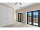 Upstairs bedroom with plush carpet and French doors leading out to a balcony at 2226 Soho Bay Ct, Tampa, FL 33606