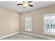 This neutral bedroom offers great natural light and features a ceiling fan and carpeted floors at 2226 Soho Bay Ct, Tampa, FL 33606