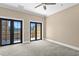 Large bedroom with plush carpet and a set of French doors leading to a balcony at 2226 Soho Bay Ct, Tampa, FL 33606