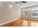 Comfortable bedroom featuring tray ceiling, hardwood floors, and plantation shutters at 2226 Soho Bay Ct, Tampa, FL 33606