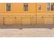 This street view shows yellow townhomes with garages and brick driveways at 2226 Soho Bay Ct, Tampa, FL 33606