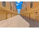 This street view shows a row of yellow townhomes with garages and brick driveways at 2226 Soho Bay Ct, Tampa, FL 33606