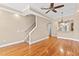 Bright living room with hardwood floors, staircase, ceiling fan and open view to kitchen with bar seating at 2226 Soho Bay Ct, Tampa, FL 33606