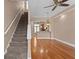 Spacious living room with hardwood floors, ceiling fan, staircase and view to kitchen with granite counters at 2226 Soho Bay Ct, Tampa, FL 33606