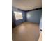 Bedroom with speckled flooring and a window, showing signs of wear and tear at 3206 Las Brisas Dr, Riverview, FL 33578