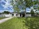 Charming single-story home featuring a well-maintained lawn and mature tree, with a long driveway and a classic facade at 3206 Las Brisas Dr, Riverview, FL 33578
