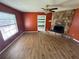 Living room with hardwood floors, stone fireplace, ceiling fan, and a window offering natural light at 3206 Las Brisas Dr, Riverview, FL 33578