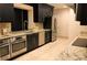 Modern kitchen featuring stainless steel appliances, dark cabinets, and granite countertops at 3301 Bayshore Blvd # 2003D, Tampa, FL 33629