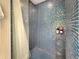 Stylish shower with iridescent glass tile surround and rainfall shower head at 3301 Bayshore Blvd # 2003D, Tampa, FL 33629