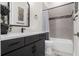 Bathroom with black hardware, modern vanity, and a shower-tub combo with stylish tile at 3610 Gulf City Rd, Ruskin, FL 33570