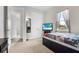 Cozy bedroom featuring a window with scenic views and a mounted TV at 3610 Gulf City Rd, Ruskin, FL 33570
