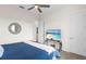 Comfortable bedroom with a mounted TV, carpeted floor, and neutral colors at 3610 Gulf City Rd, Ruskin, FL 33570