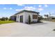 Beautiful modern home with a spacious driveway and a partial view of the backyard at 3610 Gulf City Rd, Ruskin, FL 33570