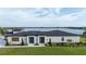 Contemporary home features a lake view, manicured lawn, modern design, and dual front doors for a grand entrance at 3610 Gulf City Rd, Ruskin, FL 33570