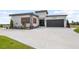Modern home with a two-car garage, well maintained landscaping, and a spacious driveway at 3610 Gulf City Rd, Ruskin, FL 33570