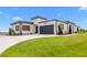 Beautiful modern home with a two-car garage, stylish landscaping, and a lush green lawn at 3610 Gulf City Rd, Ruskin, FL 33570