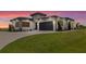 Contemporary home featuring a lush lawn, a driveway, and a stylish two-car garage at 3610 Gulf City Rd, Ruskin, FL 33570