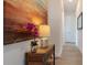 Elegant hallway with wood-look tile, console table and decorative artwork creates a warm and inviting entry at 3610 Gulf City Rd, Ruskin, FL 33570