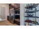 Kitchen featuring stainless appliances, double ovens, dark wood cabinets and wine storage on shelves at 3610 Gulf City Rd, Ruskin, FL 33570