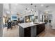 Open-concept kitchen featuring a large island, pendant lighting, and modern stainless steel appliances at 3610 Gulf City Rd, Ruskin, FL 33570