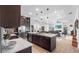 Contemporary kitchen with an island, pendant lights, dark cabinets, stainless appliances and open layout at 3610 Gulf City Rd, Ruskin, FL 33570
