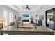 Spacious living room with a fireplace, TV, modern decor, tray ceiling, and access to the outdoor pool area at 3610 Gulf City Rd, Ruskin, FL 33570