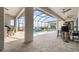 Screened-in pool area with travertine tile, ceiling fans, and a beautiful pool at 3610 Gulf City Rd, Ruskin, FL 33570