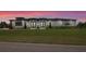 Inviting rear view of home with a lush lawn and manicured landscaping at 3610 Gulf City Rd, Ruskin, FL 33570