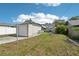 Backyard view with lush lawn, garden, detached garage and patio area at 3611 4Th N Ave, St Petersburg, FL 33713