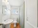 Cozy bathroom with pedestal sink, toilet, tub with shower, and ample lighting at 3611 4Th N Ave, St Petersburg, FL 33713