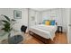 Bright bedroom features a queen bed, wood floors, and sun-filled windows at 3611 4Th N Ave, St Petersburg, FL 33713