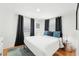 Cozy bedroom with hardwood floors, queen bed, and well-lit window at 3611 4Th N Ave, St Petersburg, FL 33713