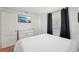 This cozy bedroom features a tv, wood floors, and a queen bed at 3611 4Th N Ave, St Petersburg, FL 33713