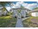 Charming home featuring a bright green door, a well-maintained lawn, and beautiful landscaping at 3611 4Th N Ave, St Petersburg, FL 33713