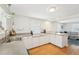 Bright kitchen with white cabinets, stainless steel sink, and adjacent living room for seamless entertaining at 3611 4Th N Ave, St Petersburg, FL 33713