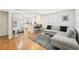 Bright living room features an open floor plan with hardwood floors and a modern gray sofa at 3611 4Th N Ave, St Petersburg, FL 33713