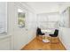 Bright sunroom with white walls, hardwood floors, and a small table with chairs to enjoy the light at 3611 4Th N Ave, St Petersburg, FL 33713
