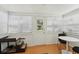 Sunroom with ample natural light, wood floors, and a cozy seating area to enjoy the outdoors from inside at 3611 4Th N Ave, St Petersburg, FL 33713