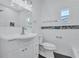 Beautiful bathroom features a tiled wall, mosaic accent stripe, and black-and-white penny tile floor at 4151 Sunrise S Dr, St Petersburg, FL 33705