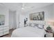 Bright bedroom featuring wood floors, a ceiling fan, and a stylish city-themed wall art at 4151 Sunrise S Dr, St Petersburg, FL 33705