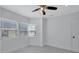 Bedroom with a large window offering natural light and a ceiling fan at 4151 Sunrise S Dr, St Petersburg, FL 33705