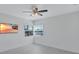 Bedroom with a large window offering natural light and a ceiling fan at 4151 Sunrise S Dr, St Petersburg, FL 33705