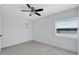 Bedroom with a large window offering natural light and a ceiling fan at 4151 Sunrise S Dr, St Petersburg, FL 33705