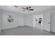 Bedroom featuring an open view to the kitchen with a ceiling fan and a large window at 4151 Sunrise S Dr, St Petersburg, FL 33705