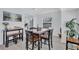 Cozy dining room has wood table with chairs and benches in a brightly lit room, with kitchen views at 4151 Sunrise S Dr, St Petersburg, FL 33705