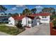 Charming two-story home with a red tile roof, white exterior, and a well-manicured front yard at 4151 Sunrise S Dr, St Petersburg, FL 33705