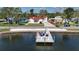 Beautiful waterfront home with private dock, featuring colorful chairs for relaxing and enjoying the water views at 4151 Sunrise S Dr, St Petersburg, FL 33705