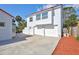 Attached two-car garage with additional parking space, featuring a well-maintained exterior and access door at 4151 Sunrise S Dr, St Petersburg, FL 33705