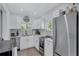 Modern kitchen with stainless steel appliances, white cabinets, and ample natural light at 4151 Sunrise S Dr, St Petersburg, FL 33705