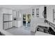 Bright kitchen featuring white cabinetry, stainless steel appliances, and access to the outdoor patio at 4151 Sunrise S Dr, St Petersburg, FL 33705